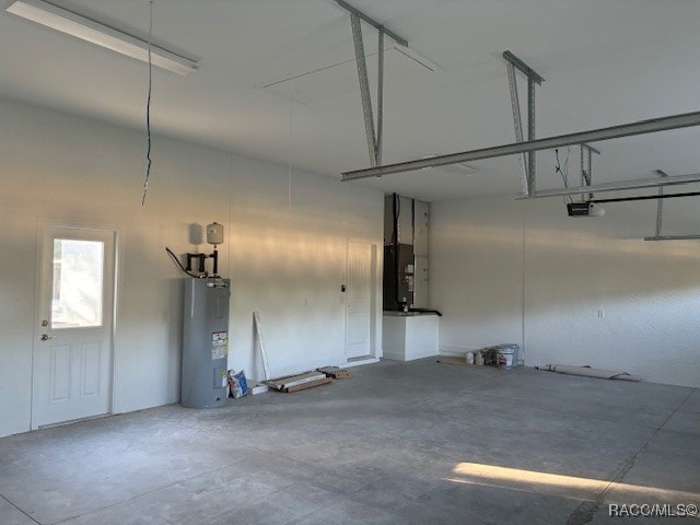 garage featuring electric water heater and a garage door opener