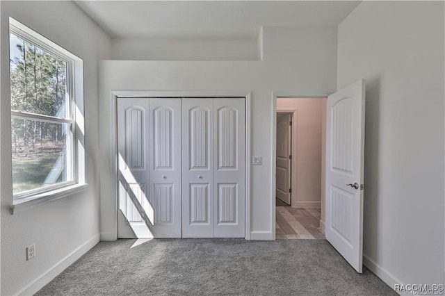 unfurnished bedroom with carpet flooring and a closet