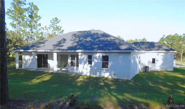 back of house with a patio area and a yard