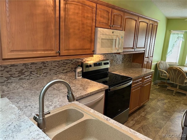 717 Whispering Pines Blvd, Inverness, FL 34453 - kitchen with white microwave, stainless steel range with electric cooktop, tasteful backsplash, and a textured ceiling