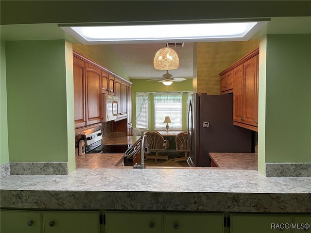 717 Whispering Pines Blvd, Inverness, FL 34453 - kitchen with appliances with stainless steel finishes, a ceiling fan, and light countertops