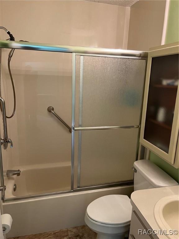 717 Whispering Pines Blvd, Inverness, FL 34453 - full bath with vanity, shower / bath combination with glass door, and tile patterned flooring