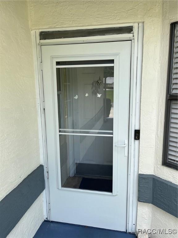 717 Whispering Pines Blvd, Inverness, FL 34453 - view of exterior entry with stucco siding