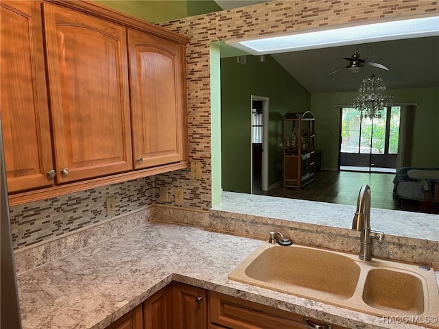 717 Whispering Pines Blvd, Inverness, FL 34453 - kitchen featuring light countertops, a ceiling fan, vaulted ceiling, and brown cabinetry