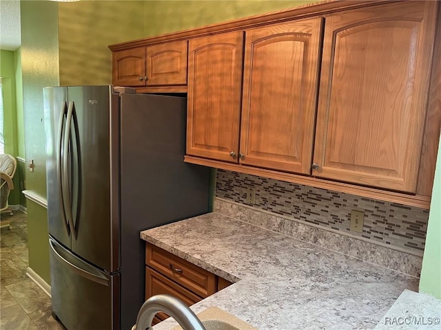 717 Whispering Pines Blvd, Inverness, FL 34453 - kitchen with freestanding refrigerator, decorative backsplash, and light countertops