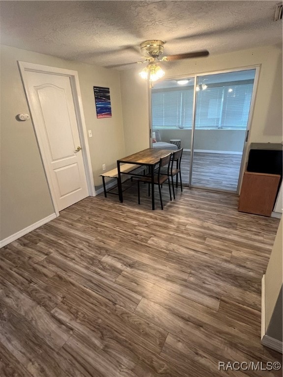 dining area with ceiling fan, a textured ceiling, and hardwood / wood-style flooring