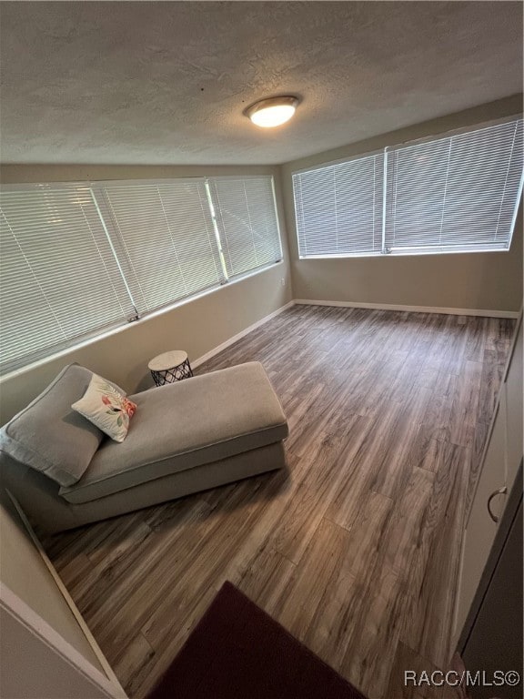 sitting room featuring hardwood / wood-style floors and a textured ceiling