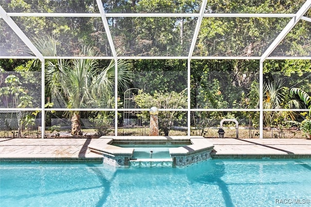 view of swimming pool featuring an in ground hot tub