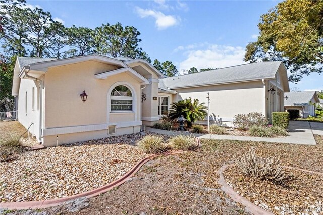 single story home featuring a front yard and a garage