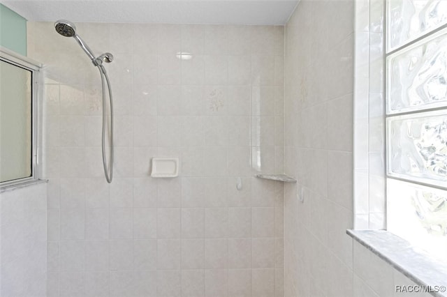 bathroom with a tile shower