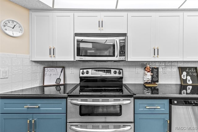 kitchen featuring white cabinets, stainless steel appliances, and blue cabinets