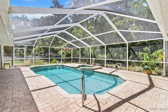 view of pool with a lanai, an in ground hot tub, and a patio