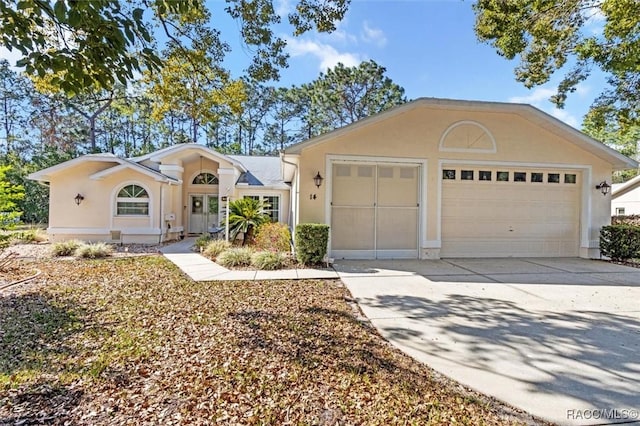 single story home with a garage, driveway, and stucco siding