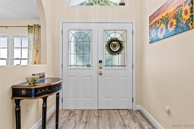 foyer with a textured ceiling and light hardwood / wood-style floors