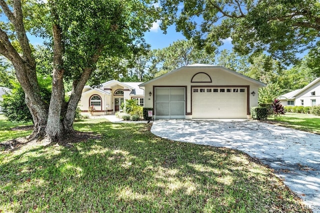 ranch-style home featuring a front lawn and a garage