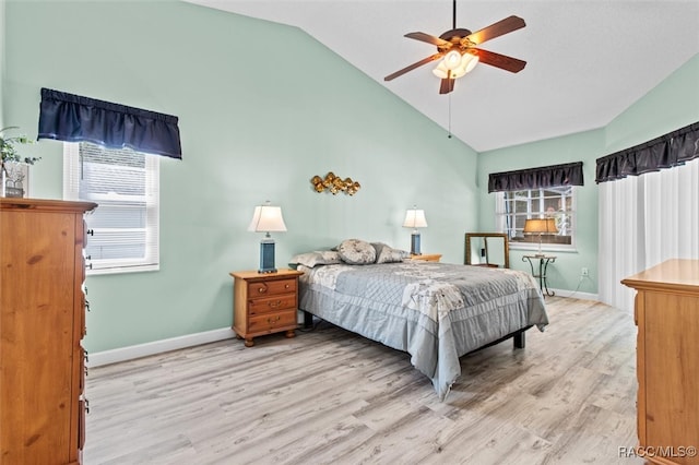 bedroom featuring ceiling fan, light wood-type flooring, and vaulted ceiling