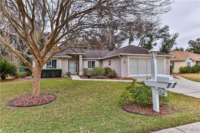 ranch-style house featuring a garage and a front yard