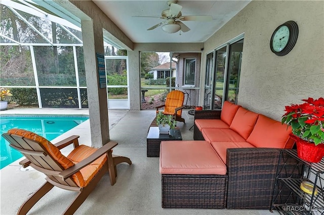 sunroom featuring ceiling fan