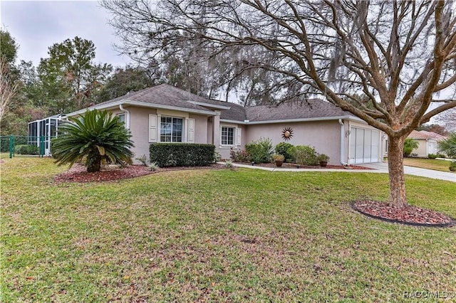 ranch-style home featuring a garage and a front yard