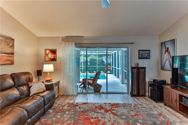 living room with lofted ceiling and light hardwood / wood-style floors