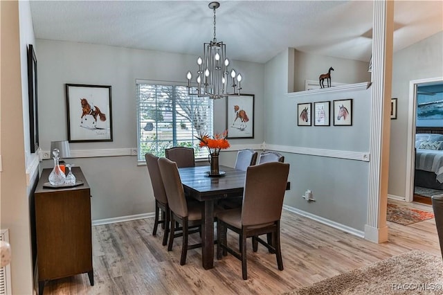 dining room featuring a chandelier and light hardwood / wood-style flooring