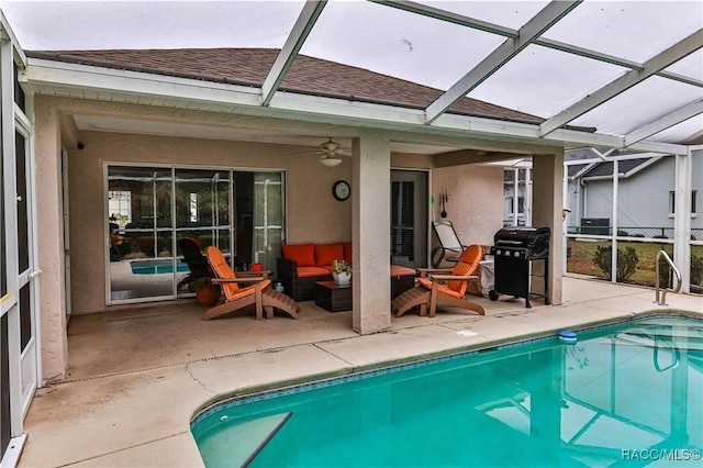 rear view of property featuring an outdoor living space, ceiling fan, glass enclosure, and a patio area