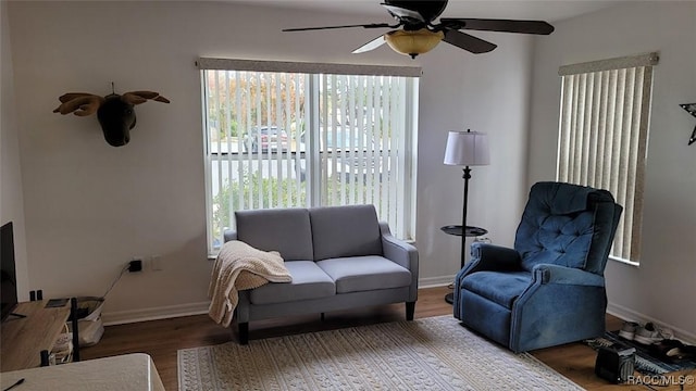 living room featuring ceiling fan and wood-type flooring