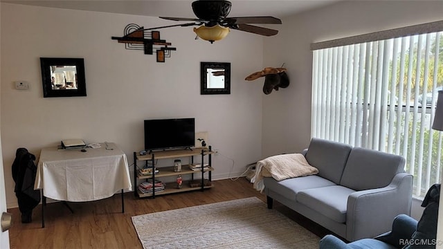 living room featuring ceiling fan and hardwood / wood-style flooring