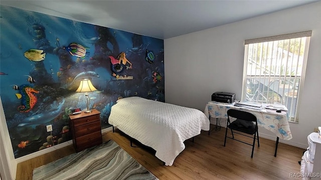 bedroom with hardwood / wood-style floors