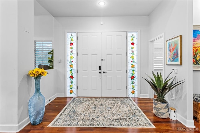 entryway with baseboards and wood finished floors