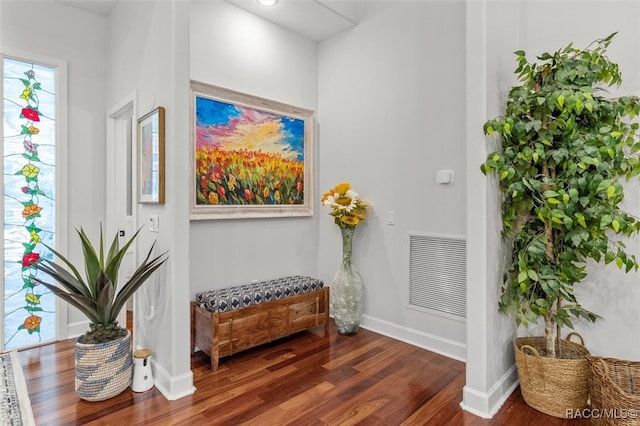 interior space featuring baseboards, visible vents, and wood finished floors