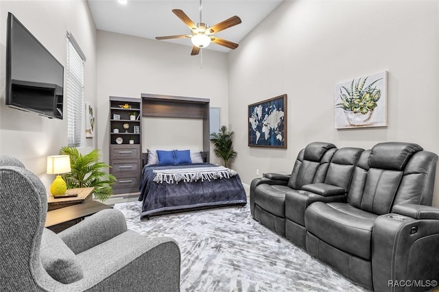 bedroom featuring ceiling fan and a towering ceiling