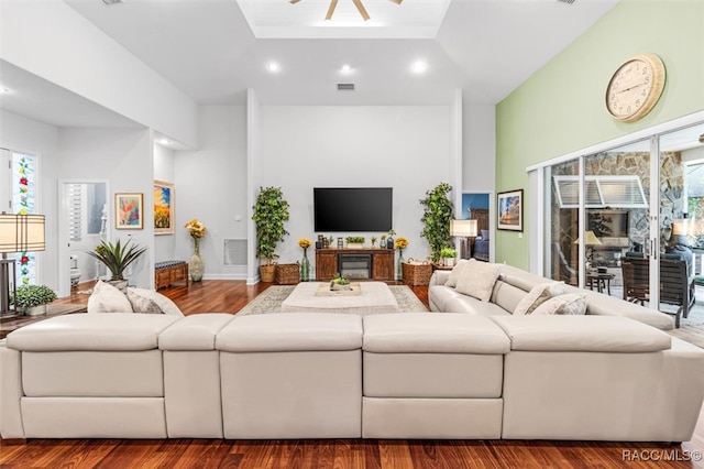 living area with wood finished floors, visible vents, and recessed lighting