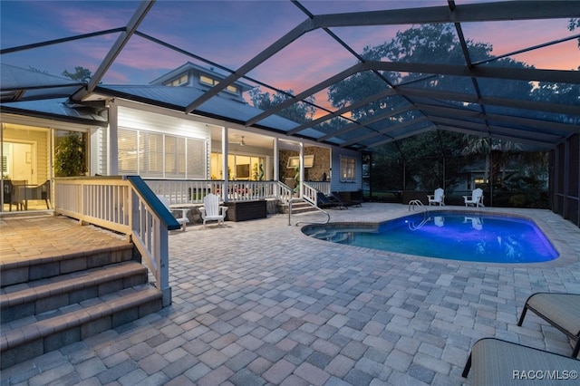 pool featuring a lanai and a patio area