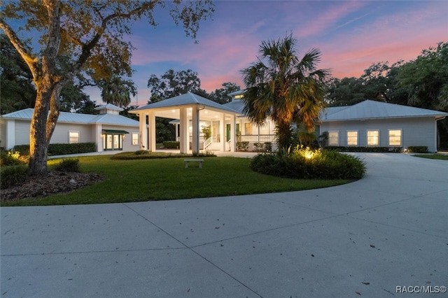 view of front of property featuring concrete driveway and a front yard