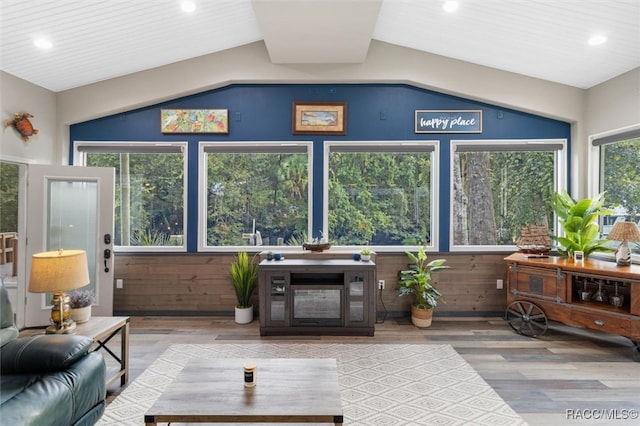 sunroom / solarium featuring a wealth of natural light and vaulted ceiling