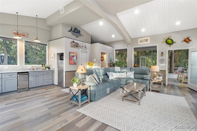 living room with light wood-style floors, recessed lighting, and high vaulted ceiling