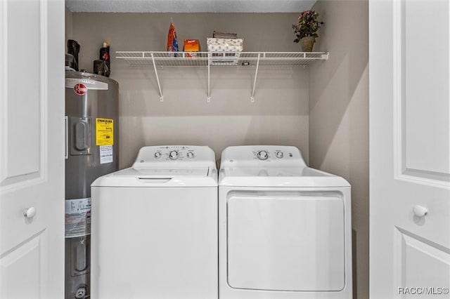 laundry area featuring laundry area, electric water heater, and washer and dryer