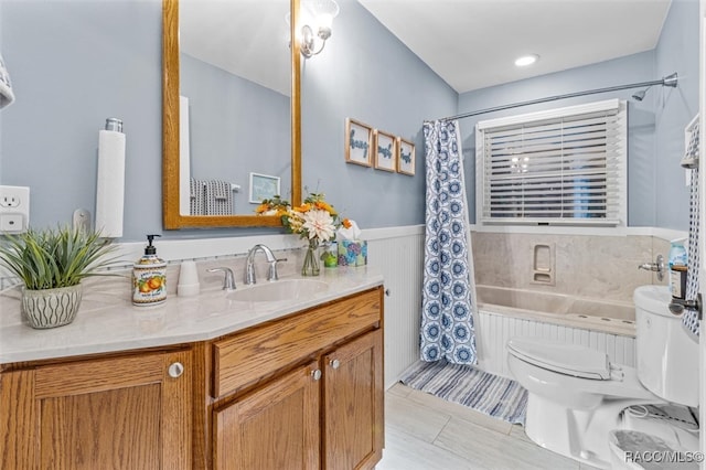 full bathroom with a wainscoted wall, toilet, shower / tub combo, vanity, and tile patterned flooring