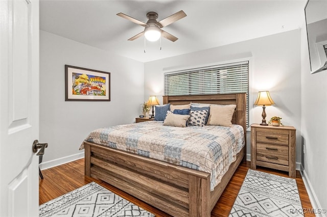 bedroom featuring wood finished floors, a ceiling fan, and baseboards