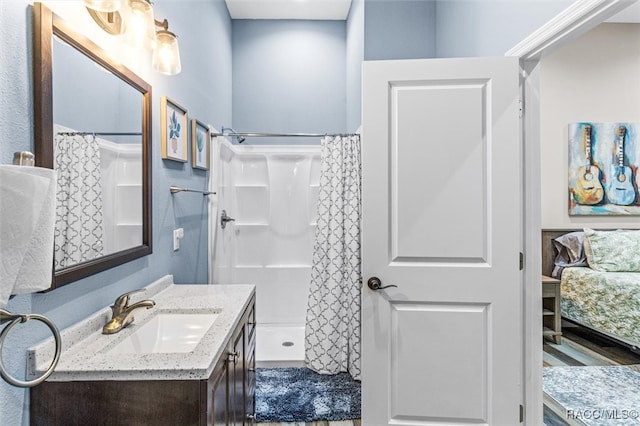 full bath with curtained shower and vanity