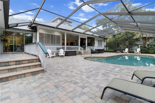 outdoor pool with a lanai and a patio area