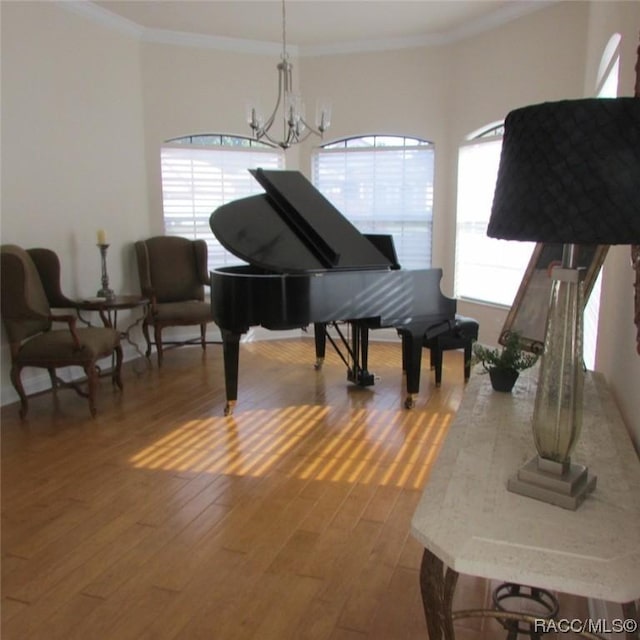 miscellaneous room featuring ornamental molding, dark hardwood / wood-style floors, and a notable chandelier