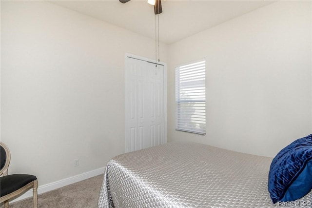 carpeted bedroom featuring ceiling fan and a closet