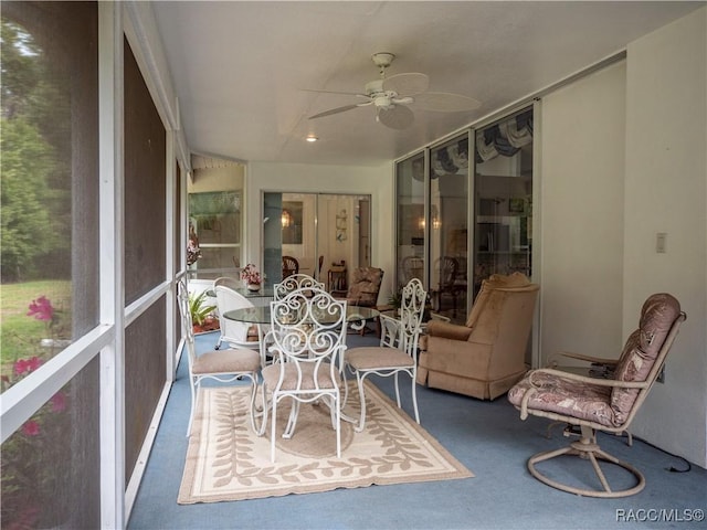 sunroom featuring ceiling fan