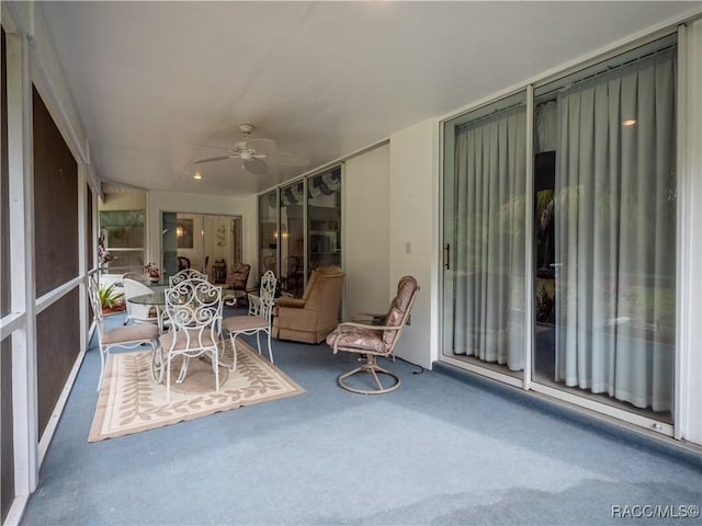 sunroom / solarium featuring ceiling fan