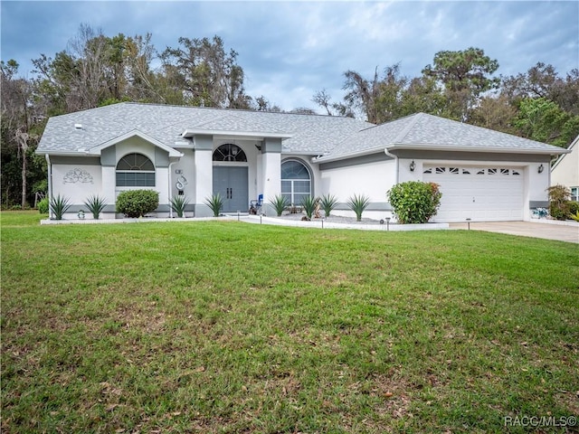 ranch-style house featuring a front yard and a garage