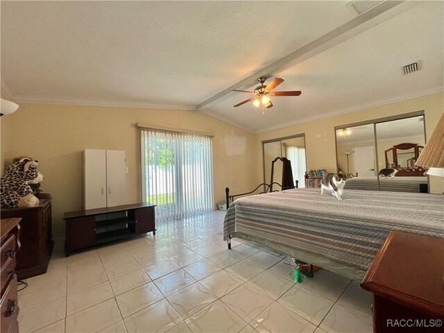 bedroom with ceiling fan, crown molding, light tile patterned floors, lofted ceiling with beams, and multiple closets