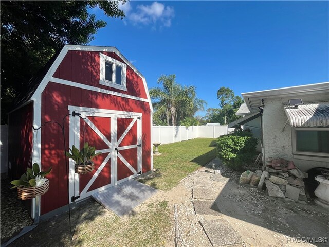 view of outdoor structure featuring a lawn