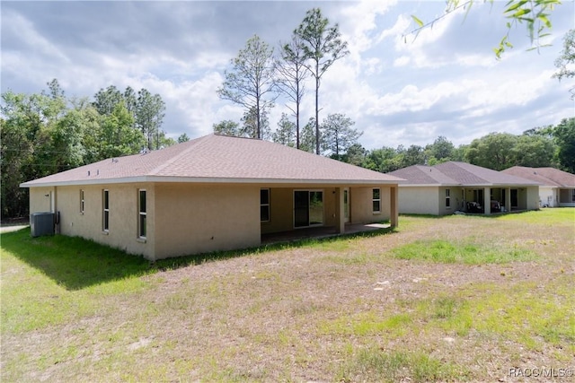 97 W Camino Ln, Citrus Springs, FL 34434 - rear view of property with central AC, stucco siding, and a yard